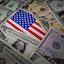 In this photo illustration, some U.S. dollar bills and an American flag are displayed on a table. (Photo by Sheldon Cooper / SOPA Images/Sipa USA)