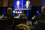 TV screen showing televised debate between Donald Trump and Kamala Harris