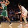 Boston Celtics forward Jayson Tatum (0) controls the ball against \New York Knicks guard RJ Barrett (9) during the first overtime at Madison Square Garden.