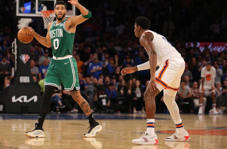 Boston Celtics forward Jayson Tatum (0) controls the ball against \New York Knicks guard RJ Barrett (9) during the first overtime at Madison Square Garden.