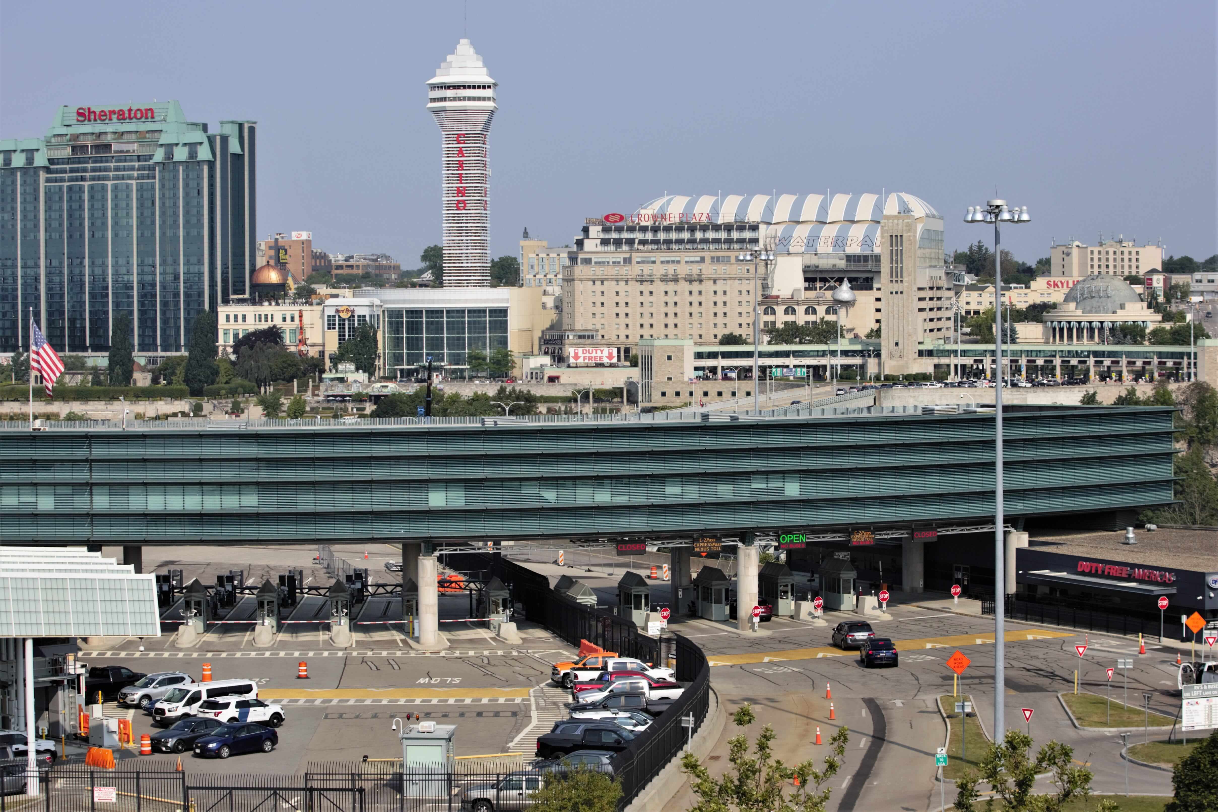 Cars wait in line at the Rainbow International Bridge in Niagara Falls on Monday, Aug. 9, 2021 to cross into Canada. The Canadian border opened up to vaccinated Americans on Monday for non-essential travel. canada