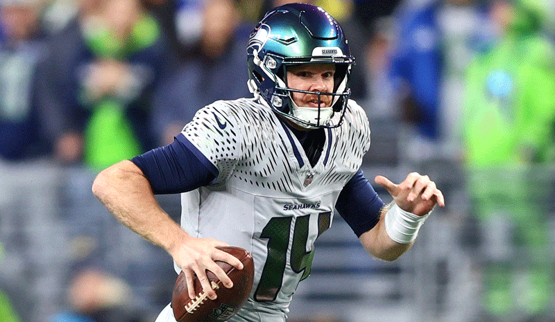 Seattle Seahawks quarterback Sam Darnold (14) runs against the Los Angeles Rams in the first half at Lumen Field.