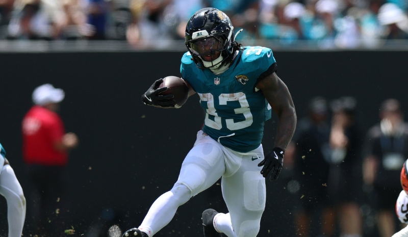 Jacksonville Jaguars running back Bhayshul Tuten (33) runs the ball.