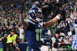 Seattle Seahawks wide receiver Jaxon Smith-Njigba (11) celebrates after scoring a touchdown against the Los Angeles Rams during the first half in the 2026 NFC Championship Game at Lumen Field. Steven Bisig-Imagn Images