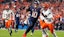 Denver Broncos quarterback Bo Nix (10) runs into the end zone.