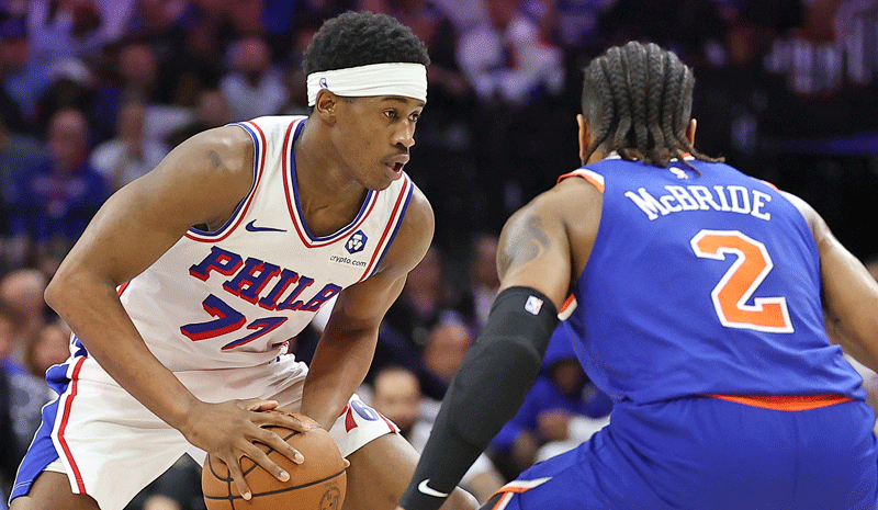Vj Edgecombe (77) controls the ball against New York Knicks guard Miles McBride.