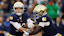Notre Dame Fighting Irish quarterback Riley Leonard hands off the ball.