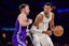 San Antonio Spurs forward Victor Wembanyama (1) moves the ball against Los Angeles Lakers guard Luka Doncic (77) during the second half at Crypto.com Arena. Gary A. Vasquez-Imagn Images