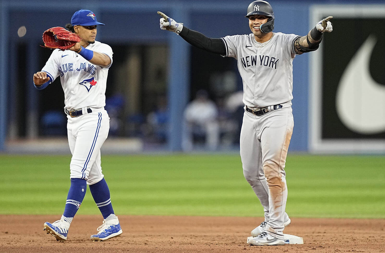 New York Yankees second baseman Gleyber Torres (25) celebrates his double as Toronto Blue Jays shortstop Santiago Espinal (5) looks for the ball during the fifth inning at Rogers Centre.