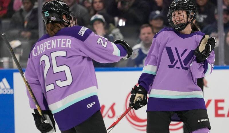 Team Kloss defender Jocelyne Larocque (3) celebrates her goal against Team King with Team Kloss forward Alex Carpenter (25)