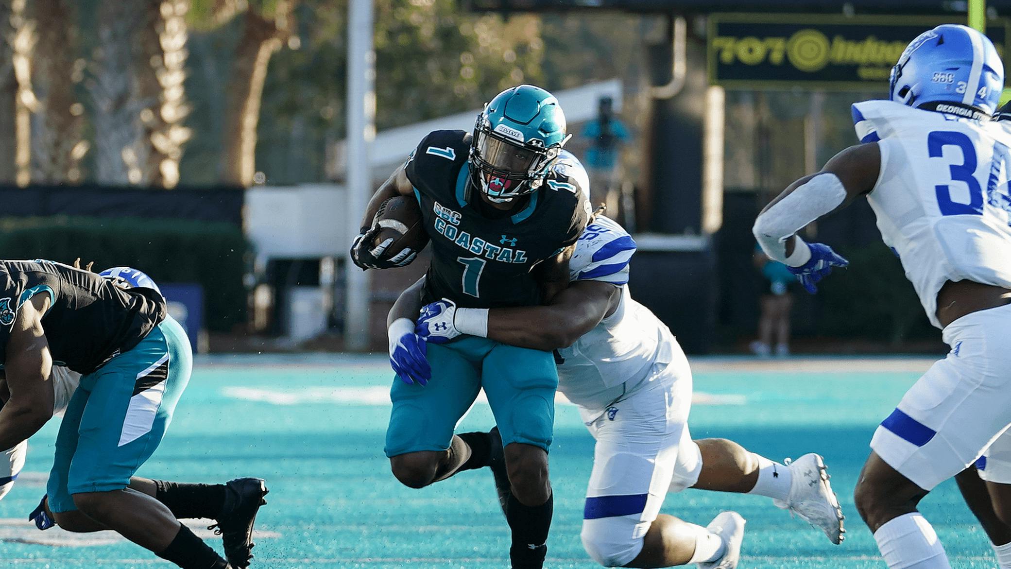 Georgia State Panthers nose guard Thomas Gore (59) tackles Coastal Carolina Chanticleers running back Braydon Bennett.