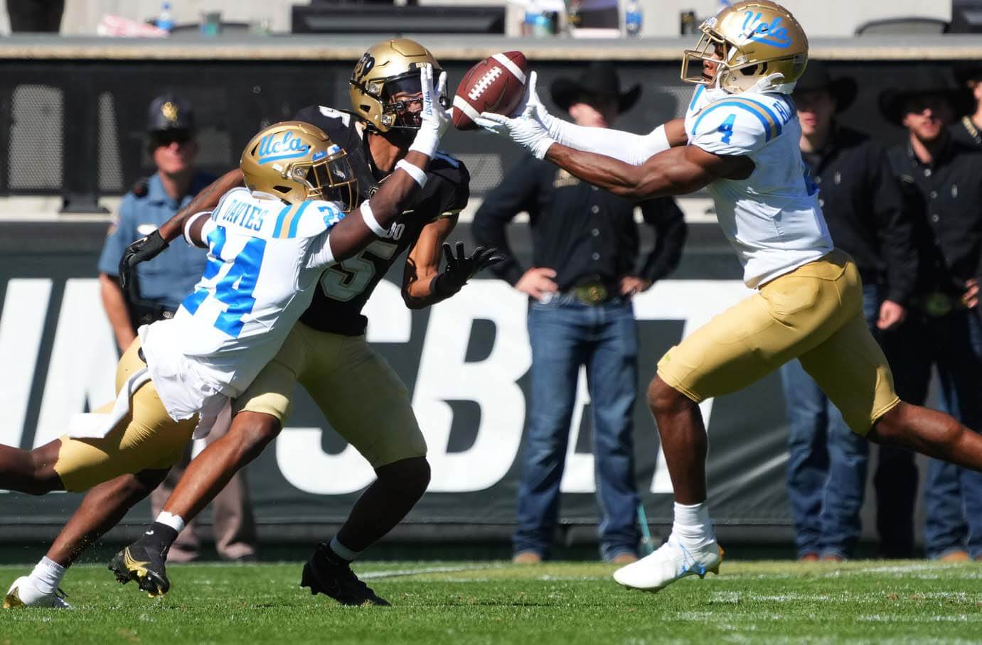 UCLA Bruins defensive back Jaylin Davies (24) and defensive back Stephan Blaylock (4) break up a pass to Colorado Buffaloes wide receiver Chase Sowell (15) in the second half at Folsom Field.