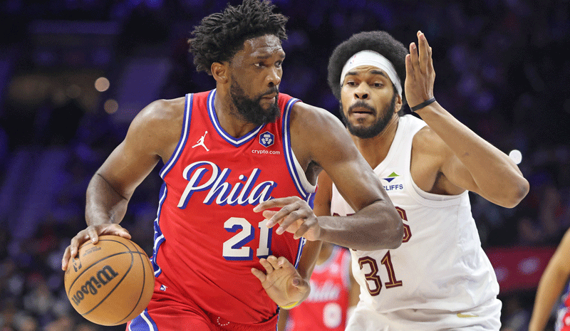 Joel Embiid (21) dribbles past Cleveland Cavaliers center Jarrett Allen (31) during the second quarter at Xfinity Mobile Arena.