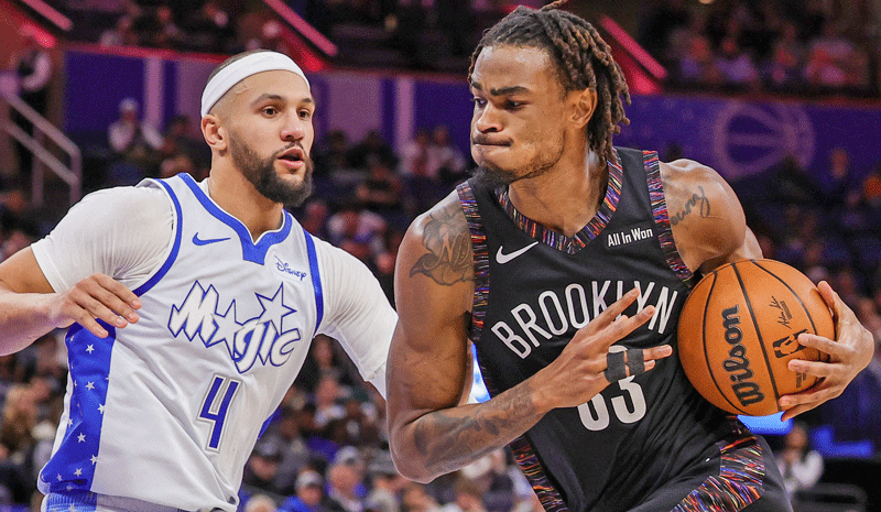 Nic Claxton (33) drives against Orlando Magic guard Jalen Suggs (4) during the second quarter at Kia Center. 