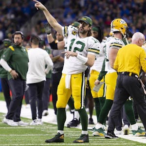 Green Bay Packers quarterback Aaron Rodgers (12) points to the other side of the field during the fourth quarter against the Detroit Lions at Ford Field.