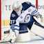 Winnipeg Jets goaltender Connor Hellebuyck (37) reaches to stop a puck during the second period of a game against the Calgary Flames at Scotiabank Saddledome.