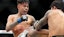 Alexandre Pantoja (red gloves) fights Brandon Royval (blue gloves).