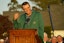 Scottie Scheffler talks to the crowd while wearing his green jacket during the final round of the Masters Tournament at Augusta National Golf Club.