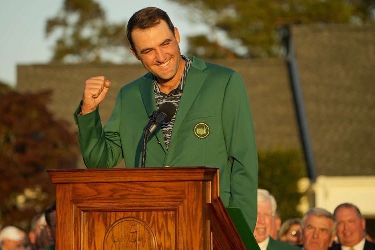 Scottie Scheffler talks to the crowd while wearing his green jacket during the final round of the Masters Tournament at Augusta National Golf Club.