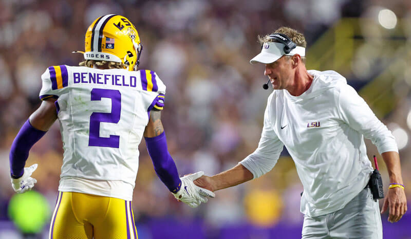 LSU head coach Lane Kiffin celebrates with Ty Benefield (2) after a defensive stop.