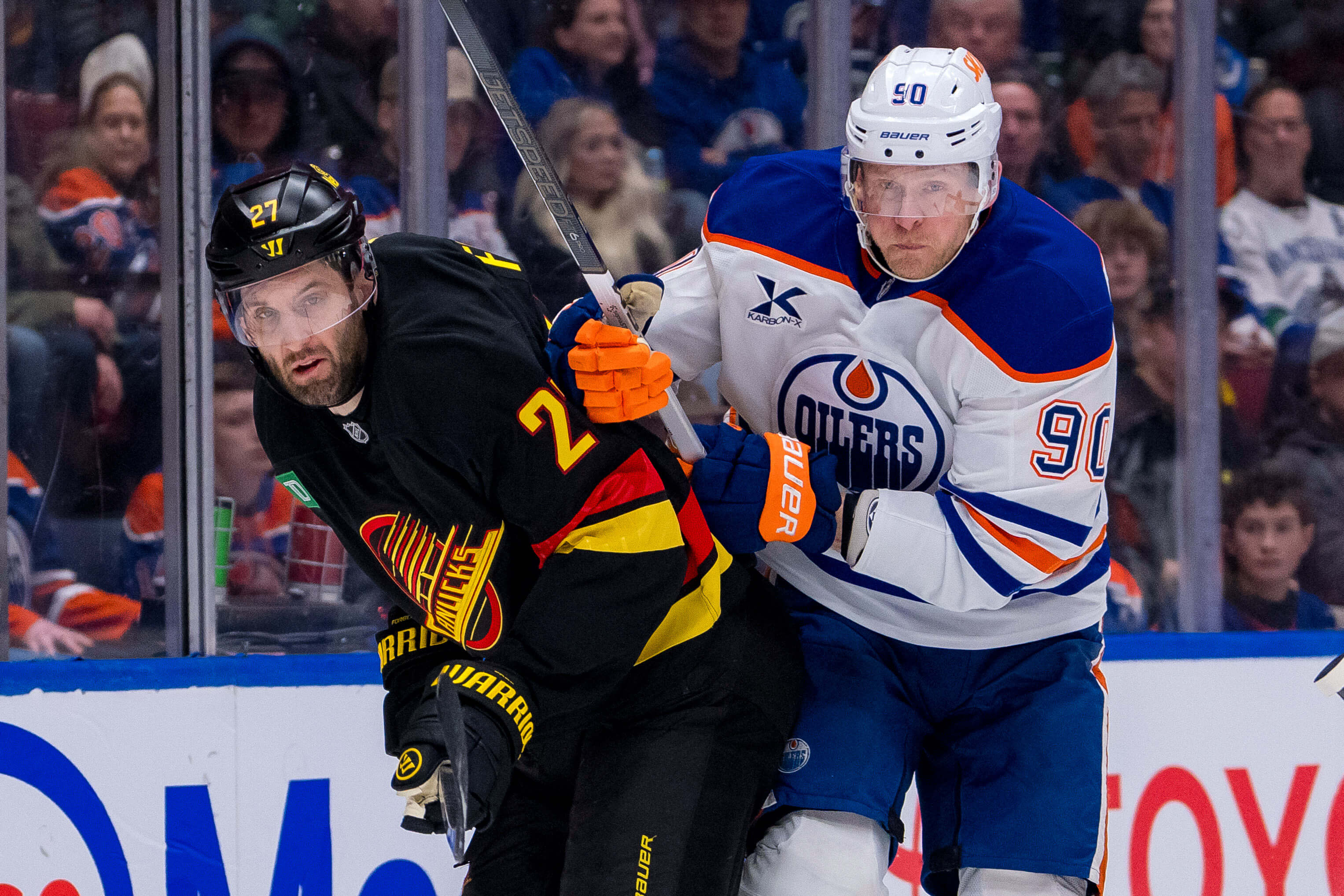 Edmonton Oilers forward Corey Perry (90) checks Vancouver Canucks defenseman Derek Forbort (27) in the first period at Rogers Arena. Mandatory Credit: Bob Frid-Imagn Images