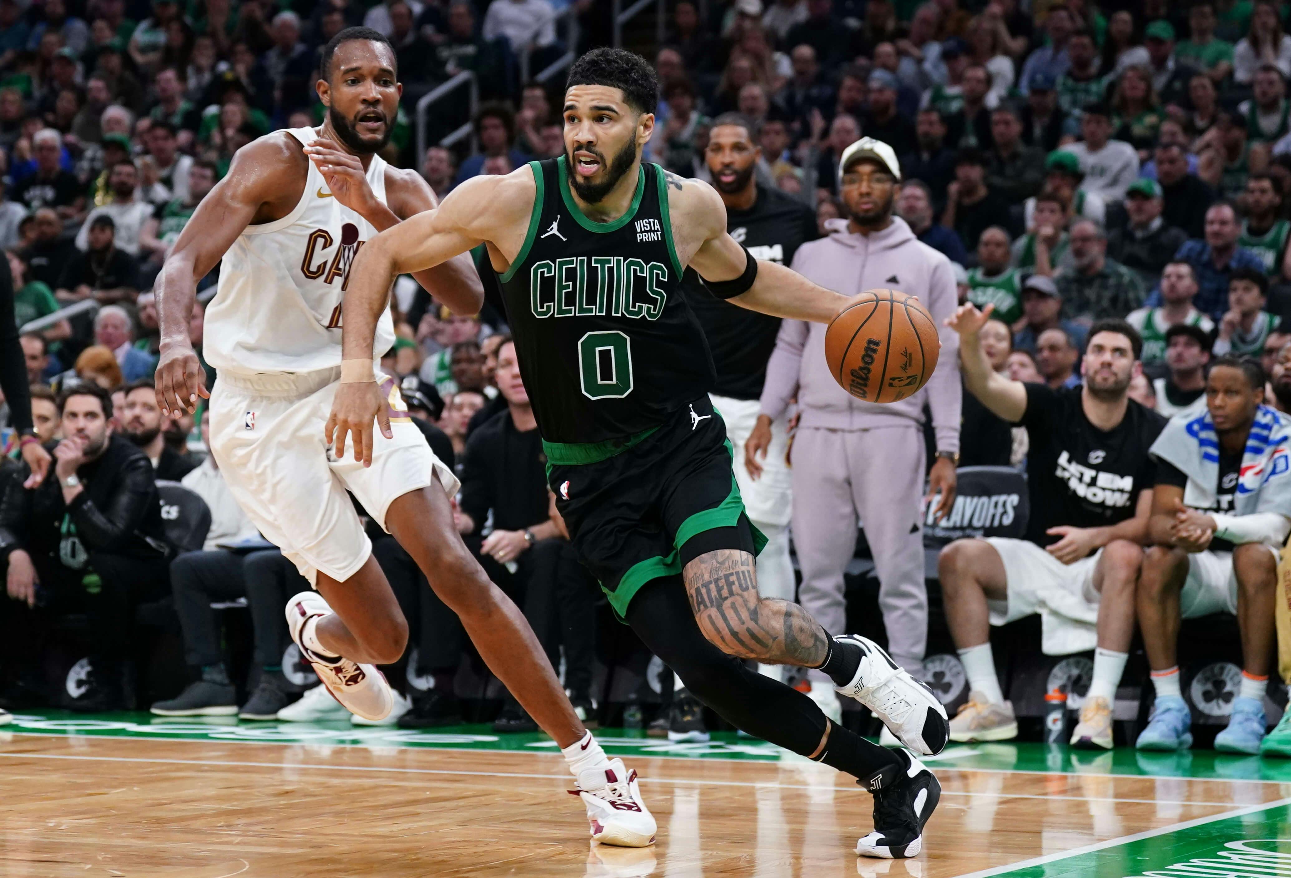 Boston Celtics forward Jayson Tatum (0) drives the ball against Cleveland Cavaliers forward Evan Mobley (4).