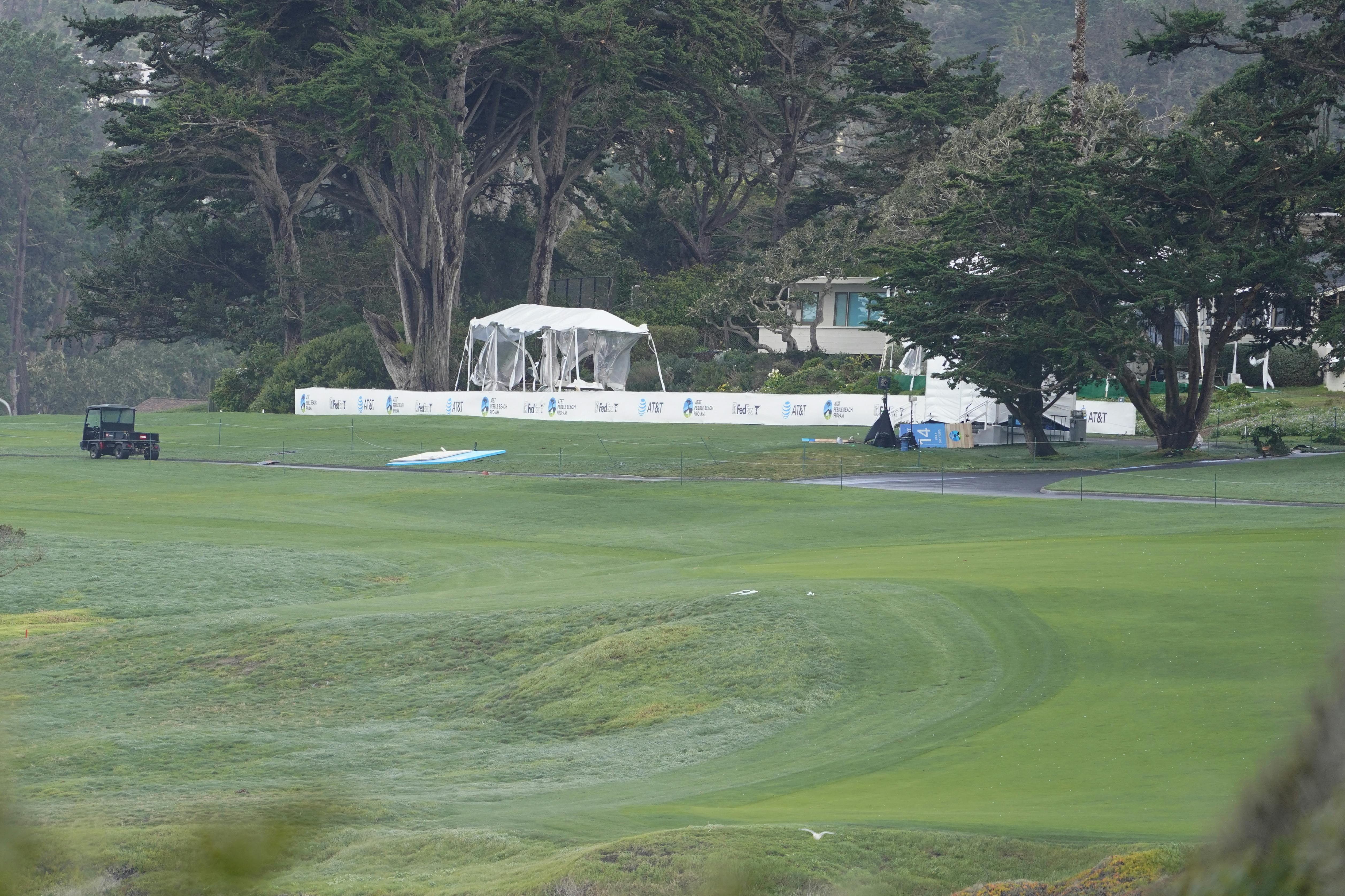 A damaged tent stands next to the 14th tee box during the postponed final round of the AT&T Pebble Beach Pro-Am golf tournament at Pebble Beach Golf Links Feb 4, 2024 in Pebble Beach, California. Michael Madrid-Imagn Images