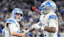 Detroit Lions quarterback Jared Goff (16) celebrates a touchdown against Dallas Cowboys scored by running back Jahmyr Gibbs.