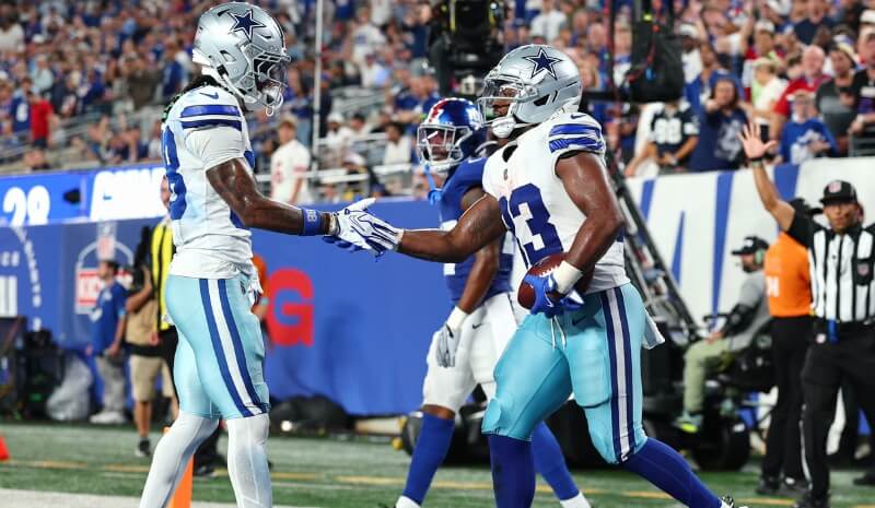 Dallas Cowboys running back Javonte Williams (33) celebrates with wide receiver CeeDee Lamb (88).