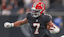 Atlanta Falcons running back Bijan Robinson (7) carries the ball against the Buffalo Bills during the first half of a game at Mercedes-Benz Stadium.