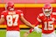 Kansas City Chiefs stars Travis Kelce and Patrick Mahomes share a low-five on the field during NFL action.