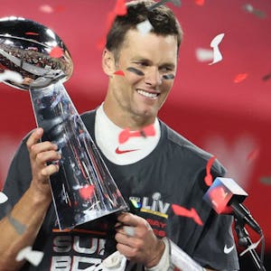 Tampa Bay Buccaneers quarterback Tom Brady (12) hoists the Vince Lombardi Trophy after defeating the Kansas City Chiefs in Super Bowl LV at Raymond James Stadium.