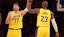 Los Angeles Lakers forward LeBron James (23) and guard Luka Doncic (77) react after a play during the first quarter.