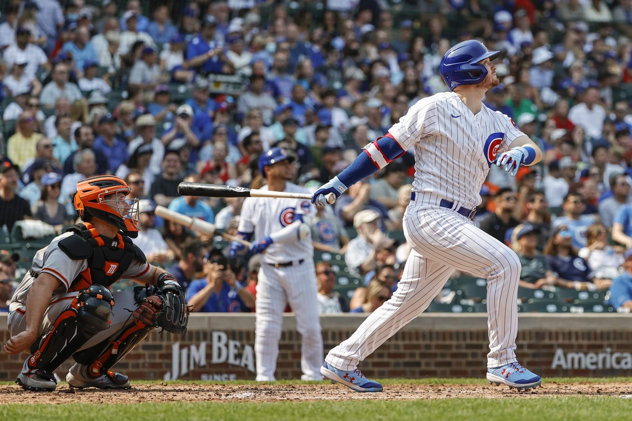 Sep 12, 2021; Chicago, Illinois, USA; Chicago Cubs center fielder Ian Happ (8) hits a solo home run against the San Francisco Giants during the fourth inning at Wrigley Field.