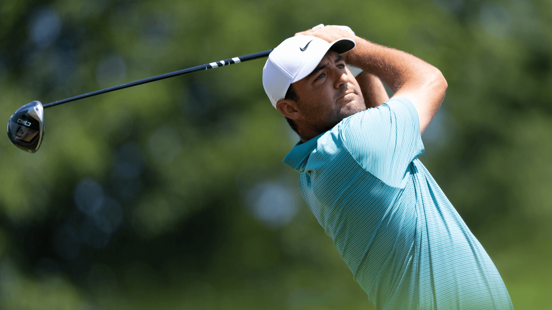 Scottie Scheffler plays his shot from the first tee during the final round of the Travelers Championship golf tournament. 