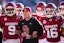 Oklahoma coach Brent Venables locks arms with players before the Armed Forces Bowl football game between the University of Oklahoma Sooners (OU) and the Navy Midshipmen at Amon G. Carter Stadium in Fort Worth, Texas, Friday, Dec. 27, 2024. Navy won 21-20.