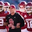 Oklahoma coach Brent Venables locks arms with players before the Armed Forces Bowl football game between the University of Oklahoma Sooners (OU) and the Navy Midshipmen at Amon G. Carter Stadium in Fort Worth, Texas, Friday, Dec. 27, 2024. Navy won 21-20.