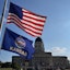 The American flag flaps in the wind above the Kansas flag on a flag pole outside the Kansas Health Institute north of the Kansas Statehouse. Jason Alatidd/Topeka Capital-Journal / USA TODAY NETWORK