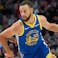 Golden State Warriors guard Stephen Curry (30) drives past Portland Trail Blazers guard Jrue Holiday (5) during the first half at Moda Center.