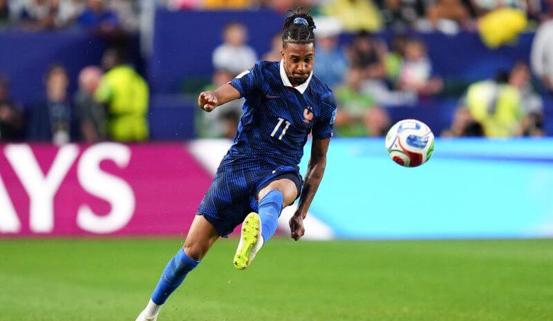 France Forward Michael Olise (11) kicks the ball.