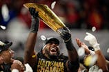 Ohio State Buckeyes wide receiver Jeremiah Smith (4) holds the trophy following the 34-23 win over the Notre Dame Fighting Irish to win the College Football Playoff National Championship at Mercedes-Benz Stadium in Atlanta on Jan. 21, 2025.
