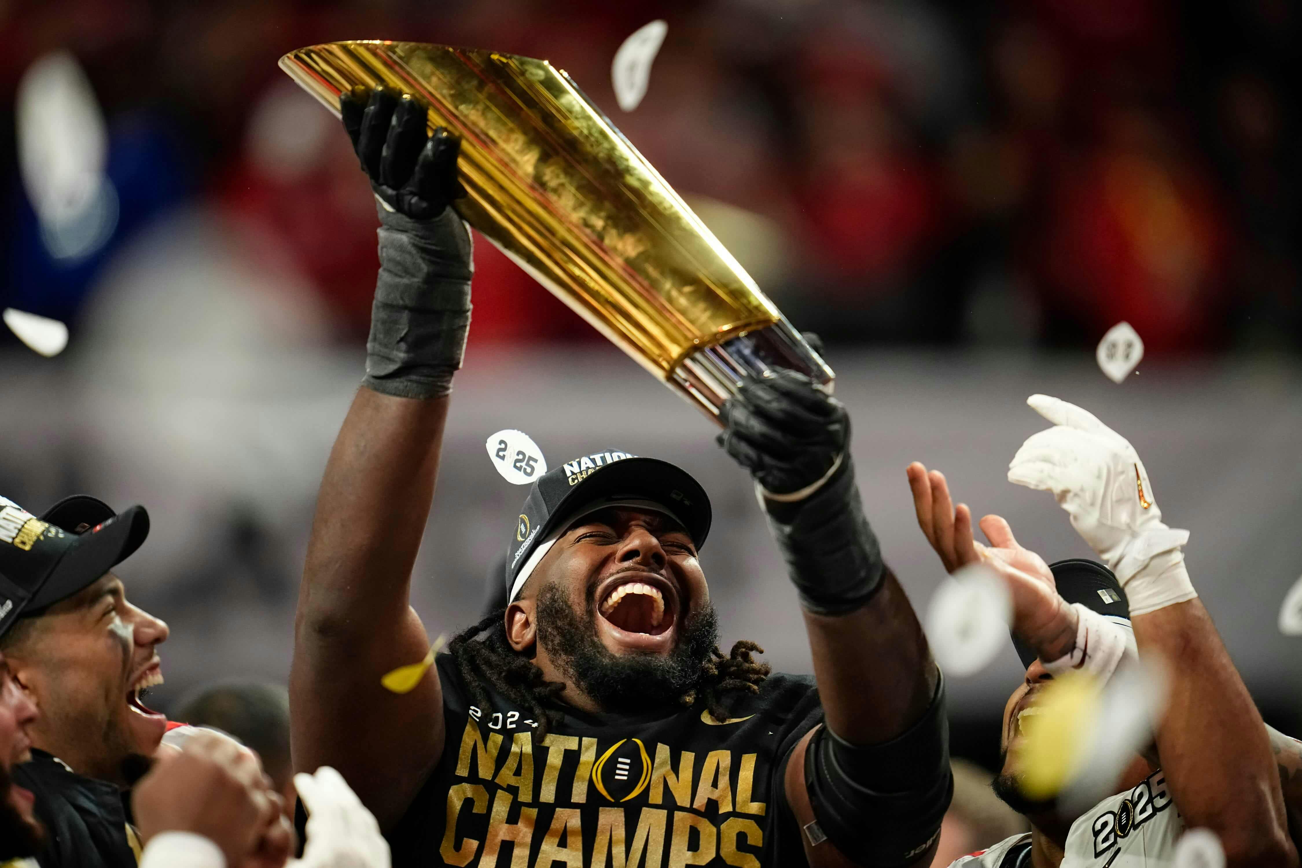 Ohio State Buckeyes wide receiver Jeremiah Smith (4) holds the trophy following the 34-23 win over the Notre Dame Fighting Irish to win the College Football Playoff National Championship at Mercedes-Benz Stadium in Atlanta on Jan. 21, 2025.