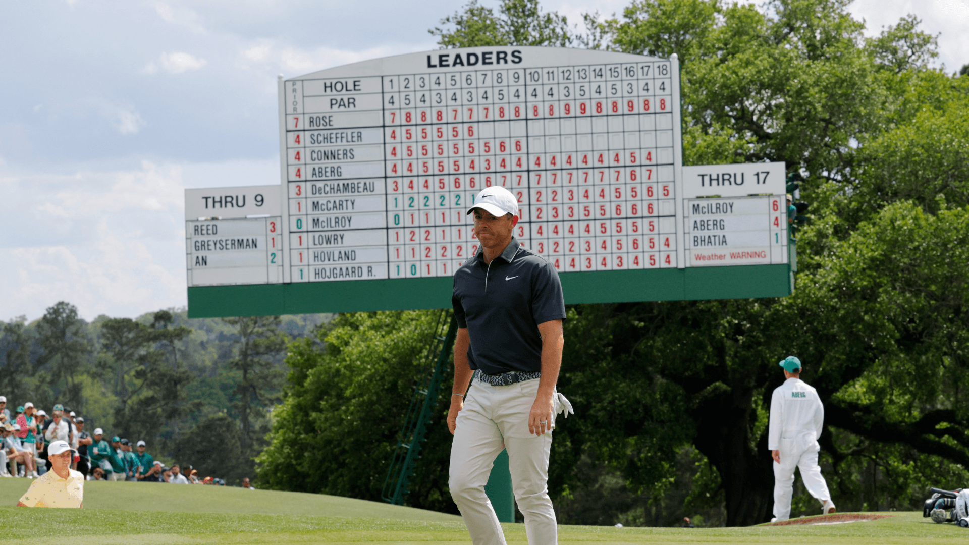 Northern Ireland's Rory McIlroy stands in front of the scoreboard on the green on the 18th hole during the second round.