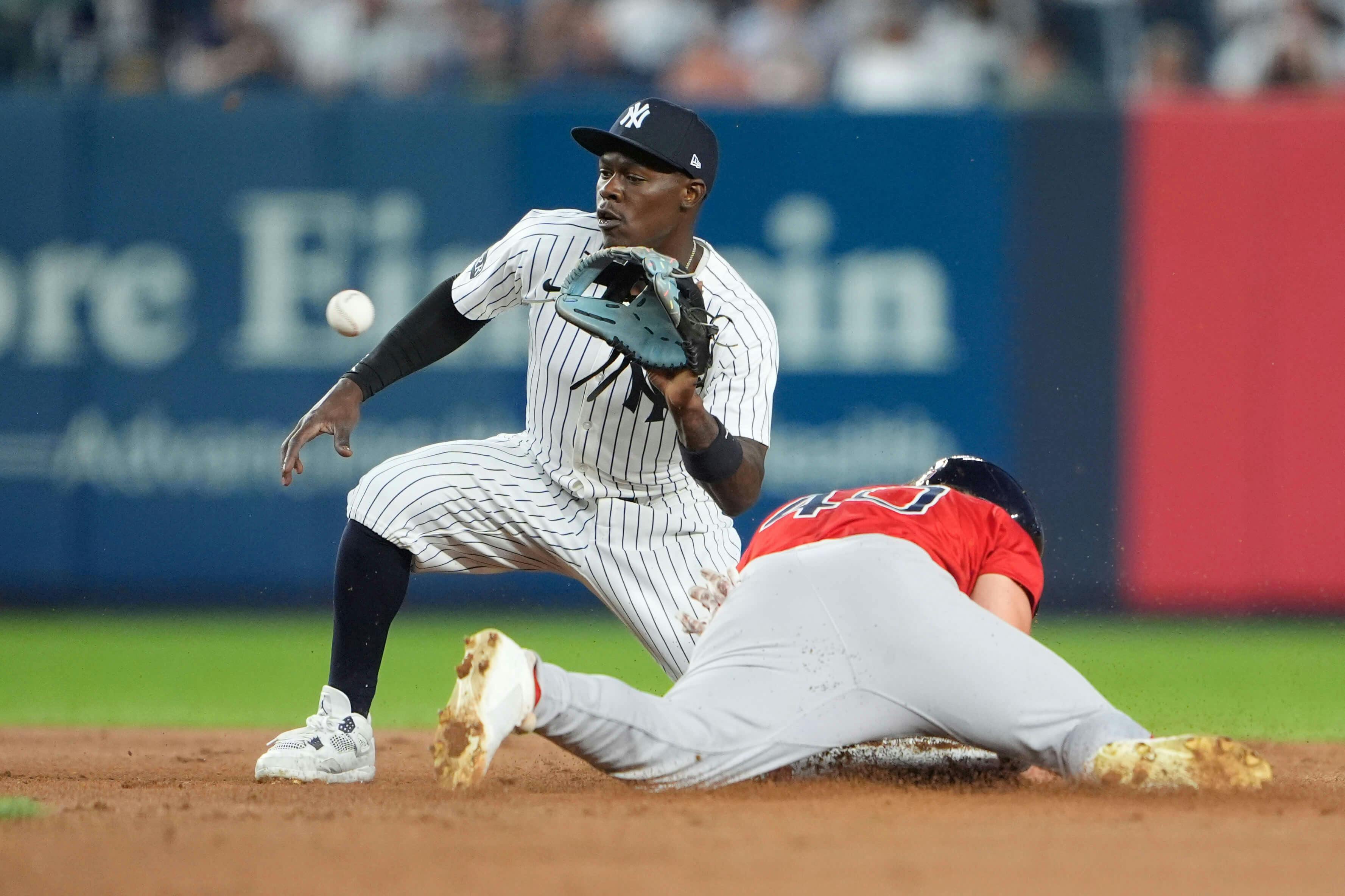 New York Yankees second baseman Jazz Chisholm Jr. (13) catches a throw and tags out Boston Red Sox designated hitter Nate Eaton (40) attempting to steal second base during the third inning at Yankee Stadium. Gregory Fisher-Imagn Images