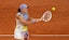 Iga Swiatek of Poland returns a shot during her match against Aryna Sabalenka.