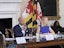 Maryland Gov. Wes Moore, left at desk, and Comptroller Brooke Lierman, right at desk, listen during a Board of Public Works meeting on July 17, 2024.