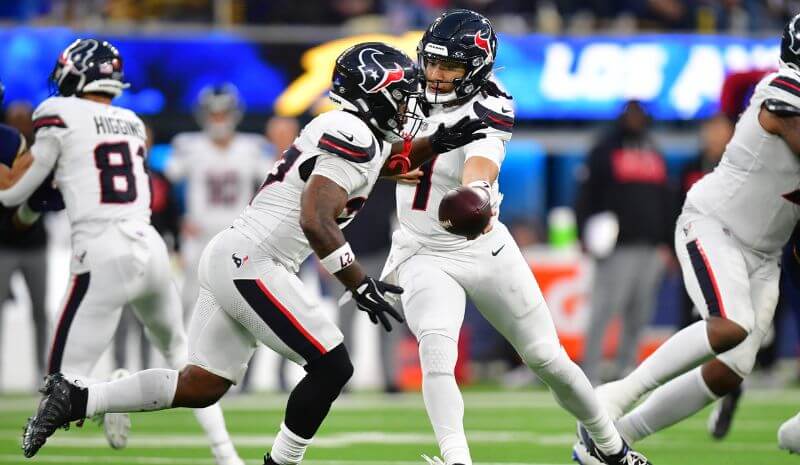 Houston Texans running back Woody Marks (27) takes the hand off.