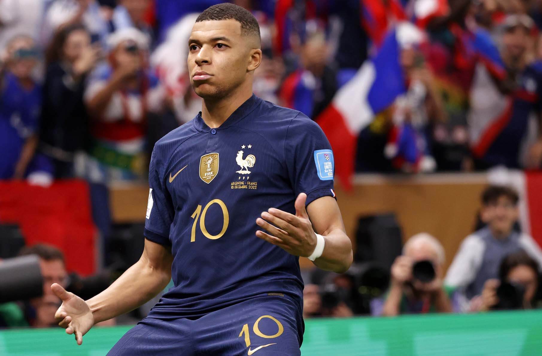 France forward Kylian Mbappe (10) celebrates after scoring a goal against Argentina on a penalty kick for his third goal of the match during extra time of the 2022 World Cup final at Lusail Stadium.