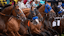 Horses break from the starting gate.