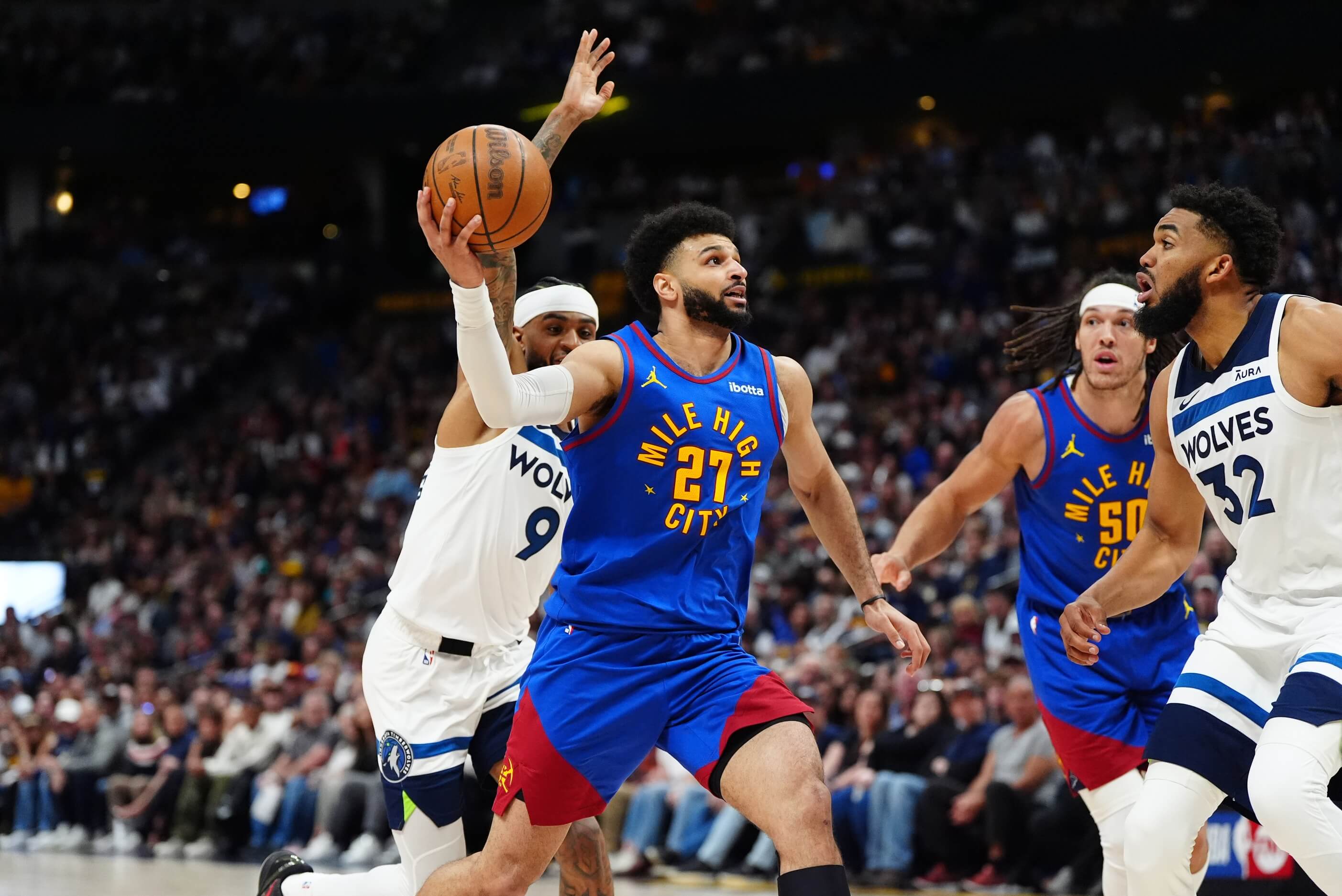 Minnesota Timberwolves guard Nickeil Alexander-Walker (9) and center Karl-Anthony Towns (32) defend against Denver Nuggets guard Jamal Murray (27) in the second half during game one of the second round for the 2024 NBA playoffs at Ball Arena.